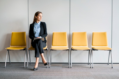 Linking Hiring to Culture-  Woman alone in a waiting room before a hiring interview.